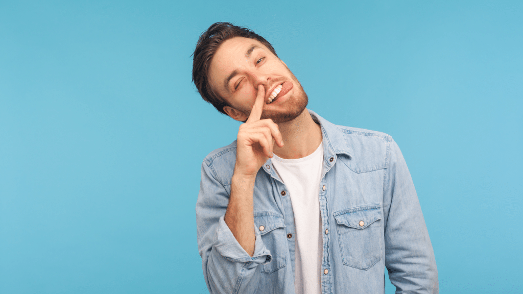 man poking his face silly